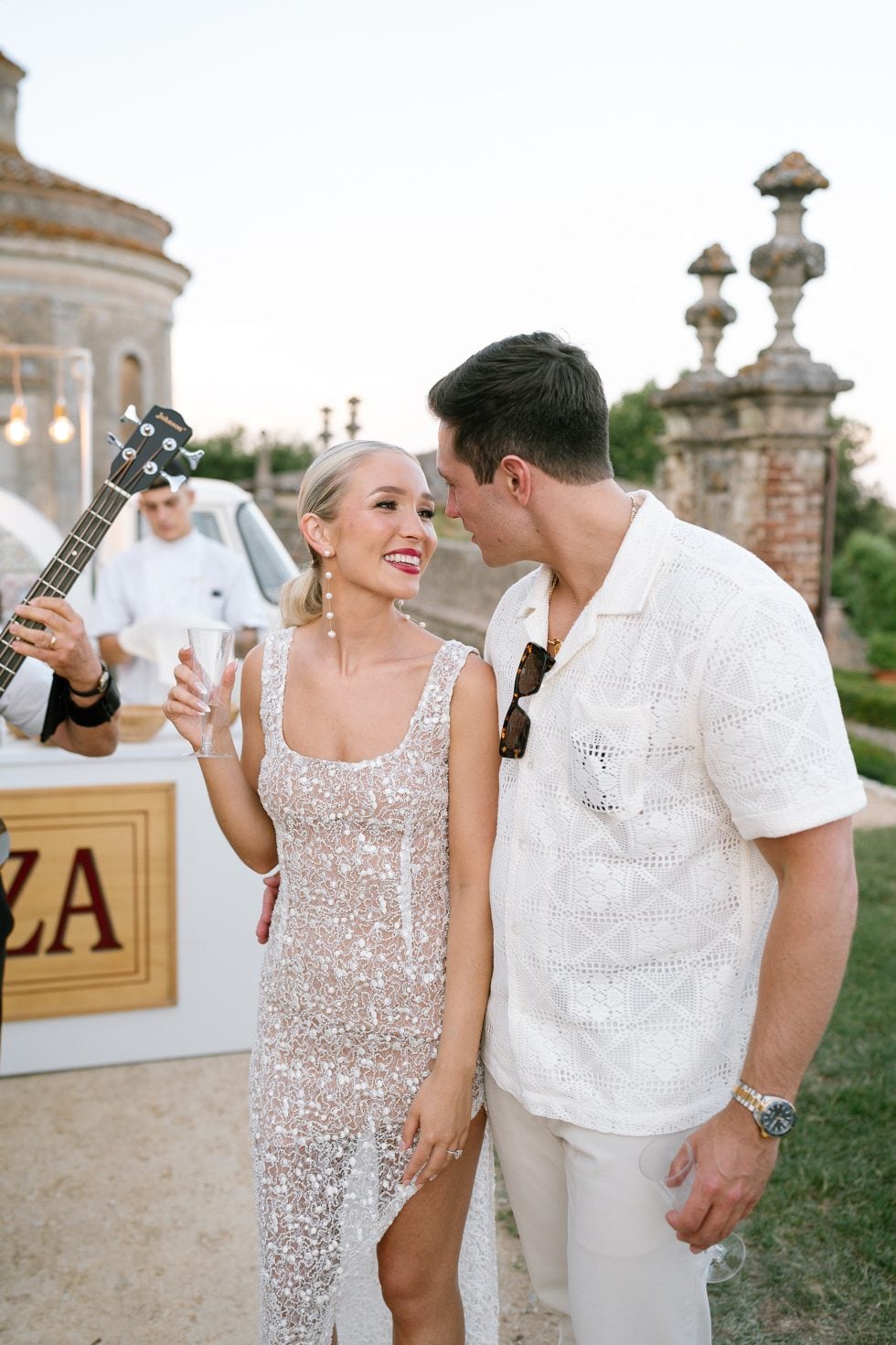 Morgan and Ryan kissing with musicians at Castello di Celsa, Siena