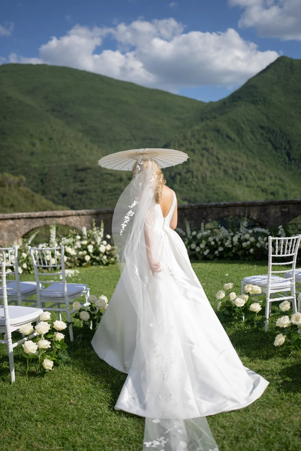 The bride with a parasol in the gardens of Abbazia di San Pietro in Valle, Umbria