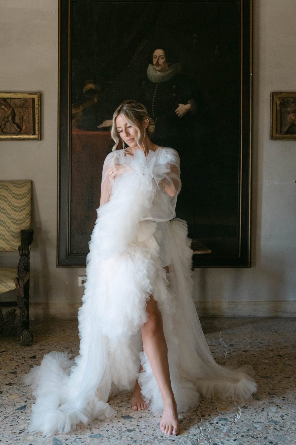 Beatrice in a feathered robe during the preparations at Castello Odescalchi di Bracciano, near Rome