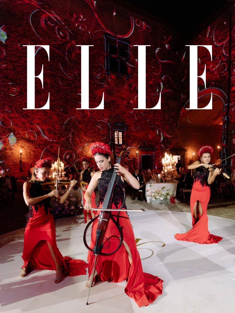 ELLE cover: string musicians in red performing in the illuminated courtyard of Castello Odescalchi at Roxana and Kyle's wedding