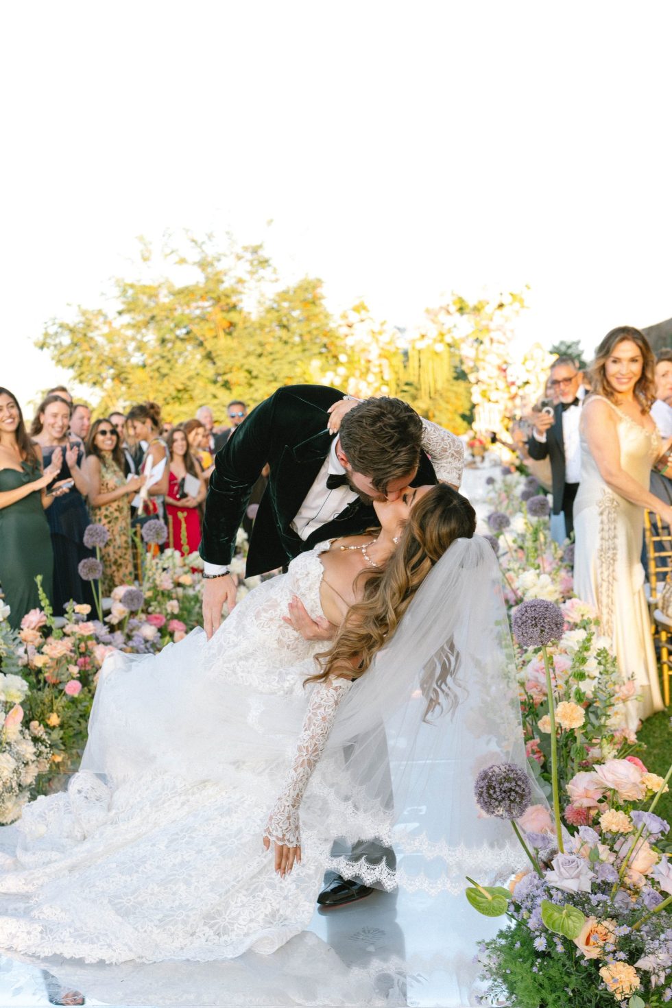 Roxana and Kyle kissing at the end of their ceremony among the flowers at Castello Odescalchi, Bracciano