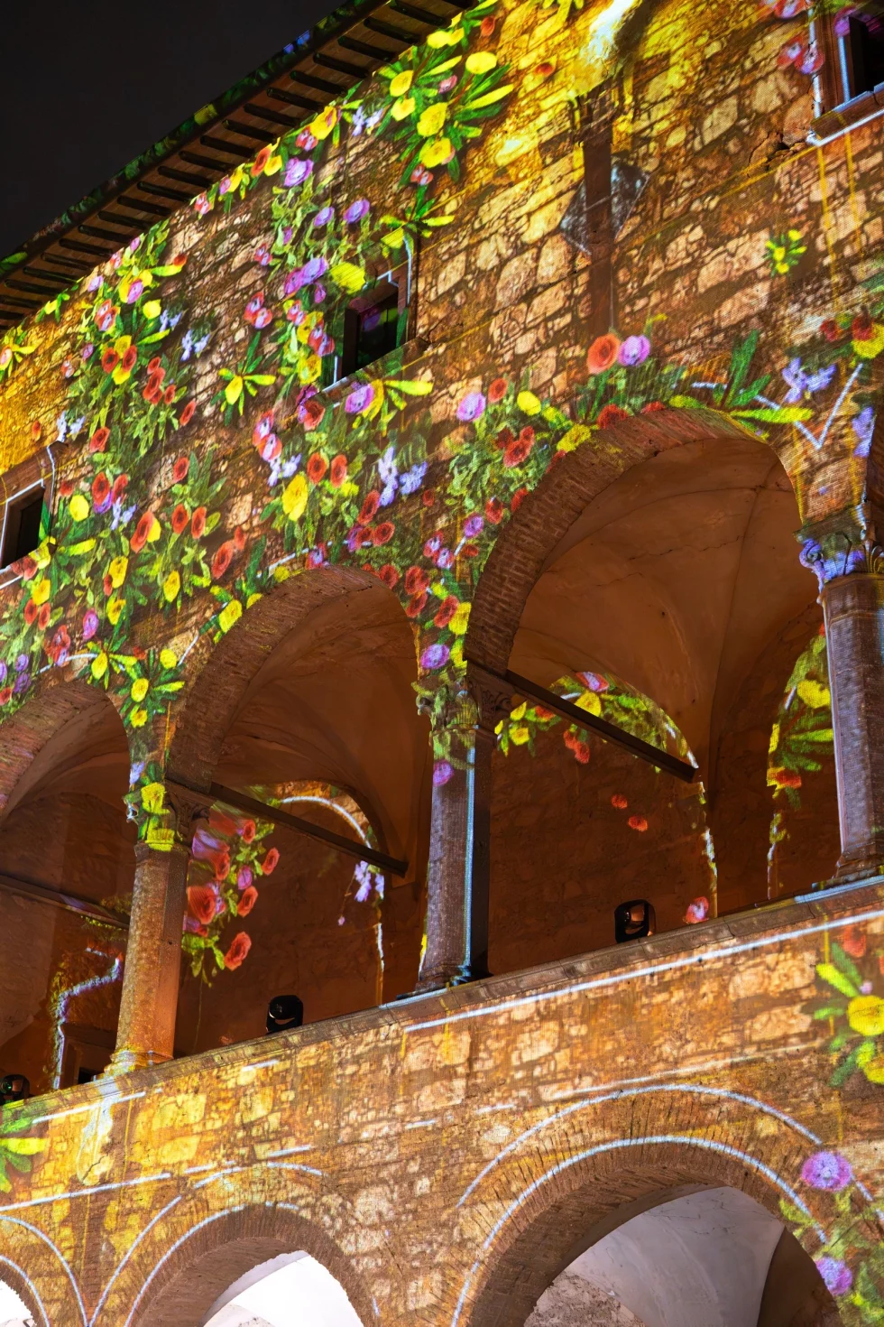 Floral light projections on the courtyard arches of Castello Odescalchi during the wedding