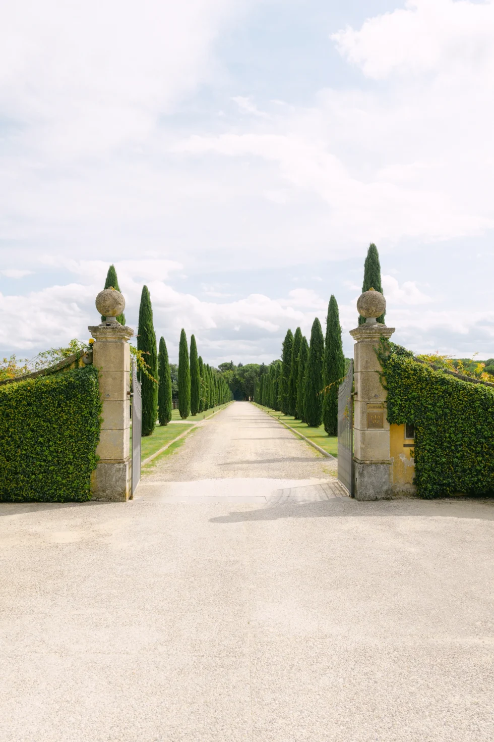The cypress-lined avenue and stone gates of the Il Borro estate in Tuscany