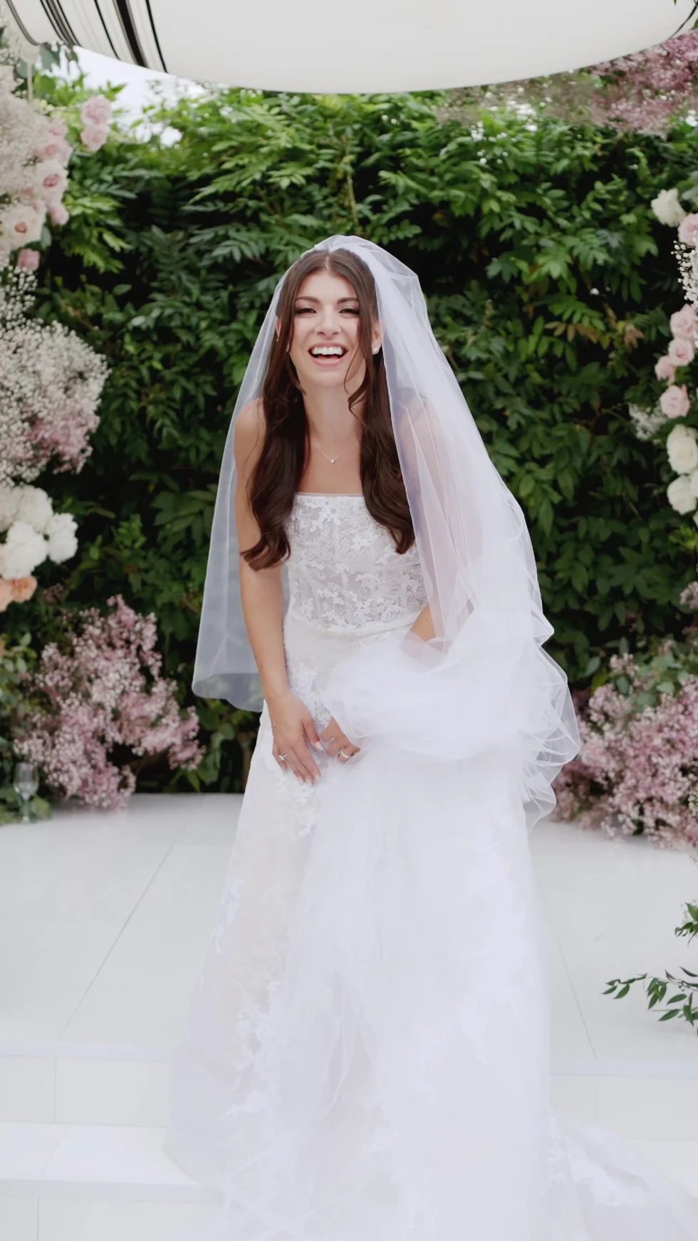 Remy laughing beneath her veil at the floral ceremony, Il Borro