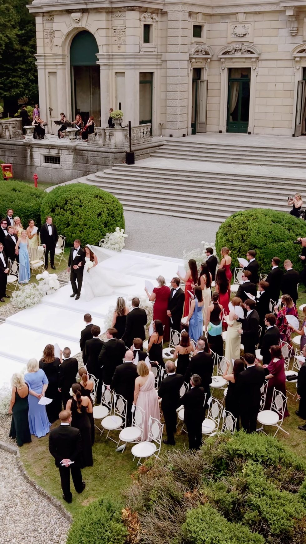 Guests gathering for the ceremony in the gardens of Villa Erba, seen from above