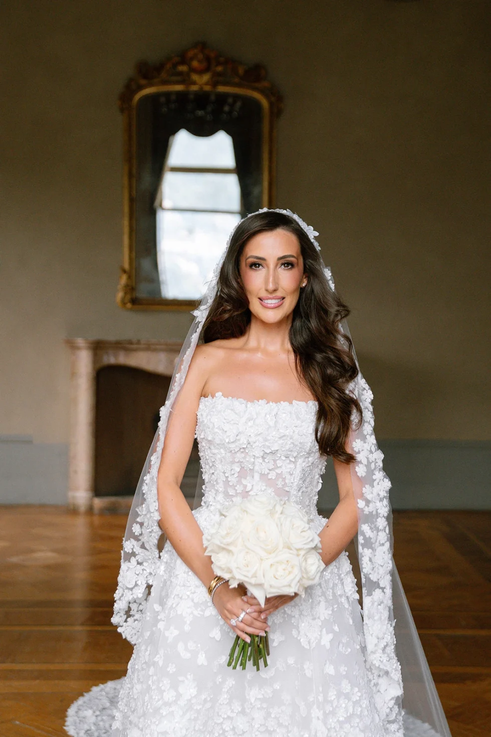 Renee with her white bouquet in a historic room of Villa Erba, Lake Como