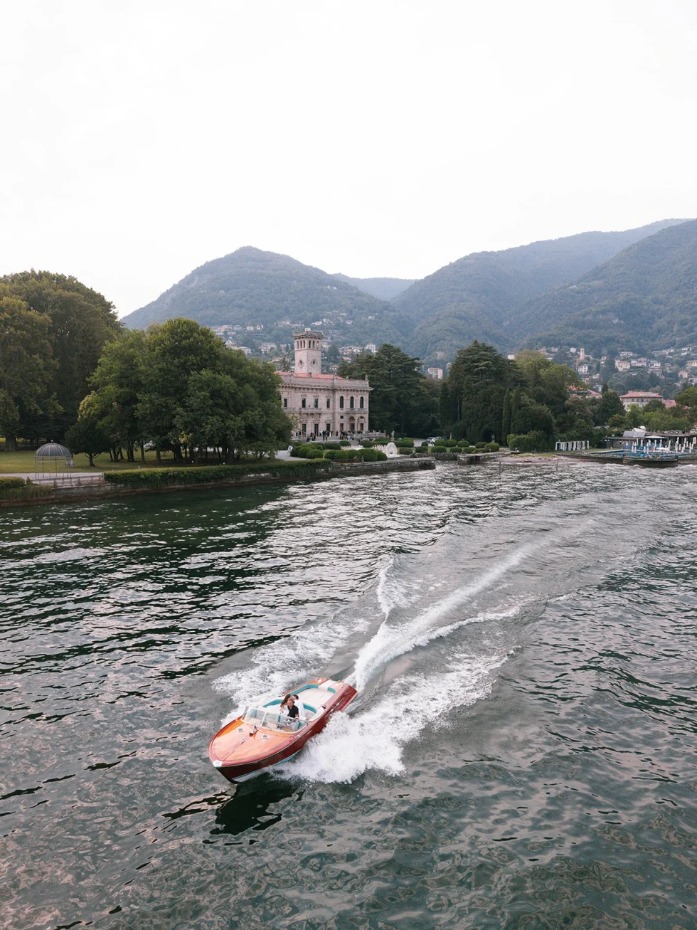 Aerial view of the couple's classic boat on Lake Como, Villa Erba wedding