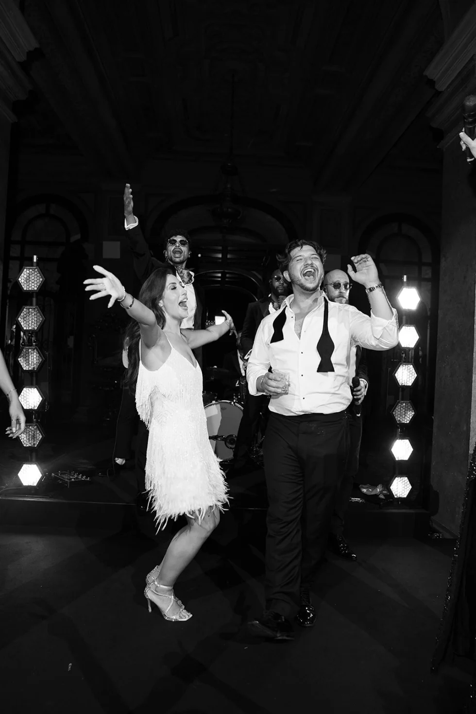 Bride and groom dancing under stage lights at the Villa Erba wedding party