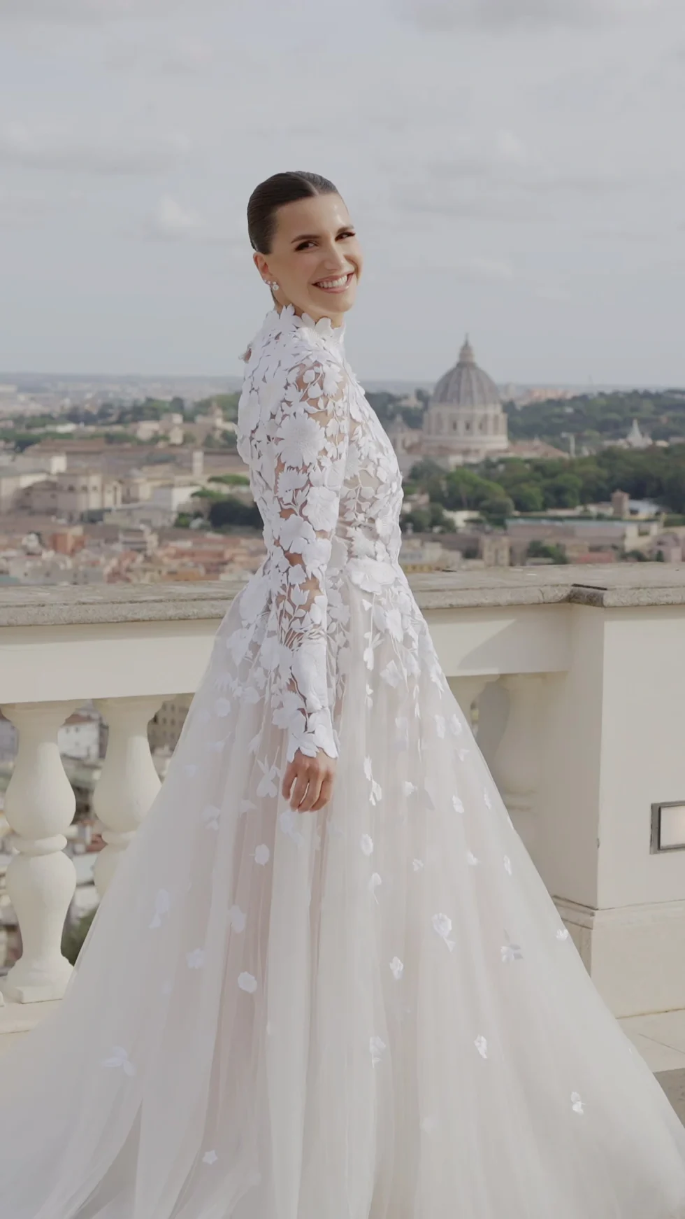 One of the most beautiful Rome wedding venues: the bride on the terrace of Villa Miani, with the dome of St. Peter's behind