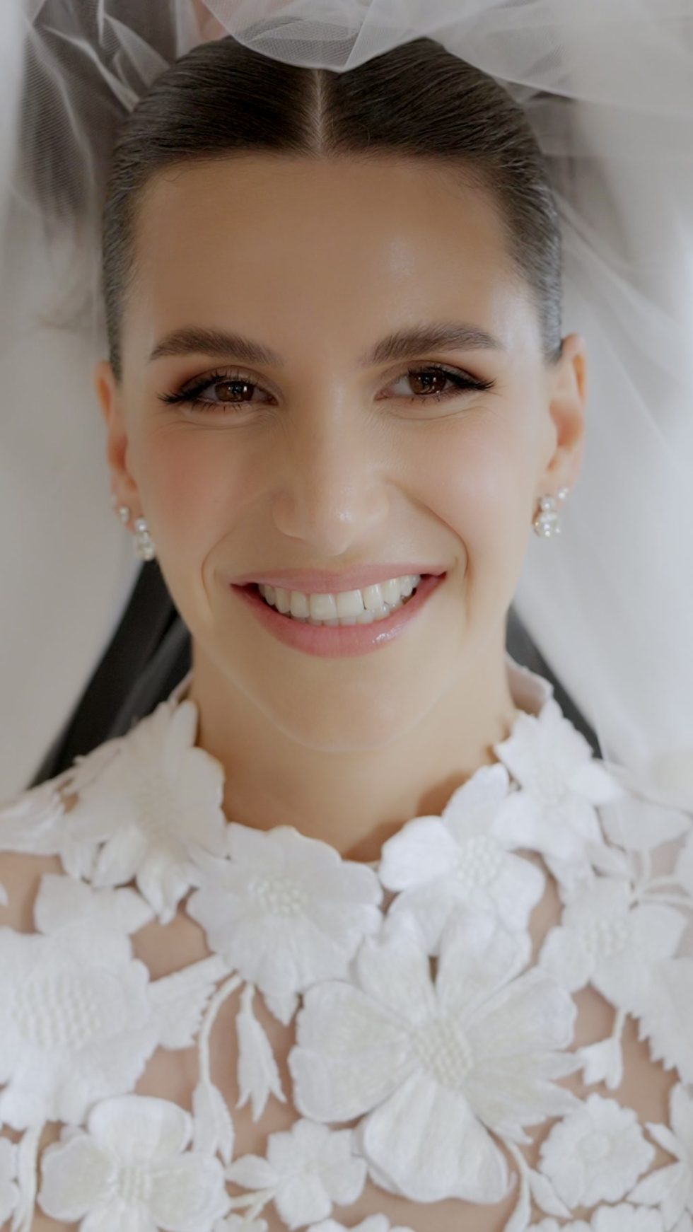 Close portrait of the bride smiling beneath her veil at Villa Miani, Rome