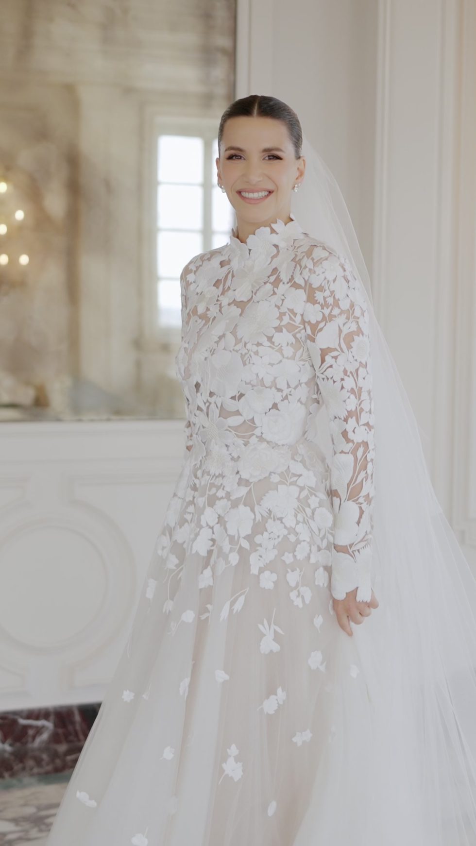 The bride in her floral lace gown and cathedral veil in a salon of Villa Miani