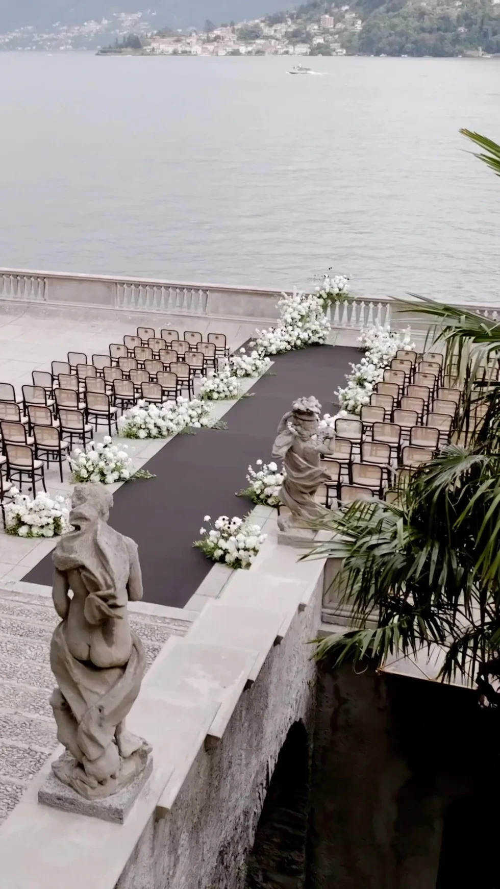 The ceremony aisle with white flowers on the lakeside terrace of Villa Pizzo