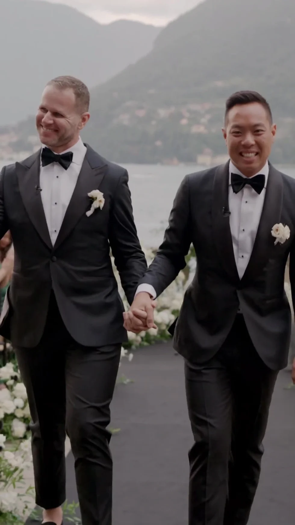 Dan and Christian walking hand in hand by the lake