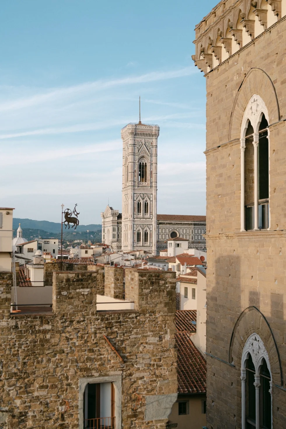 The rooftops of Florence and Giotto's bell tower at sunset
