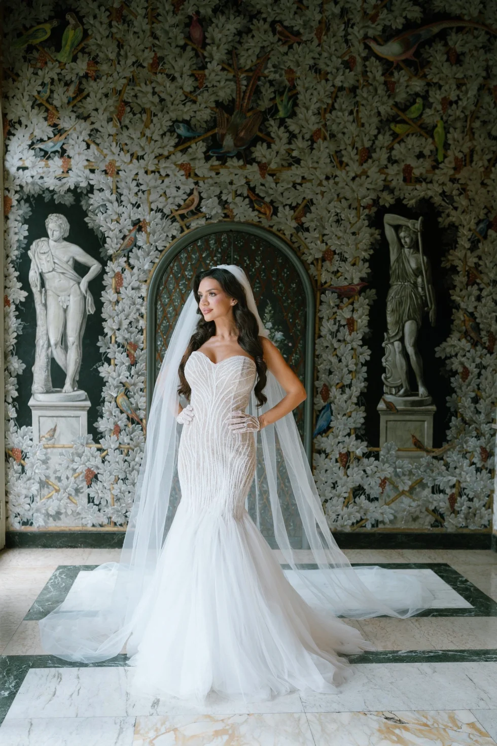 Tania in her wedding gown and cathedral veil in the frescoed grotto of Villa Miani, Rome