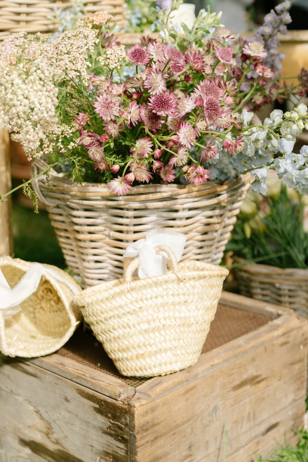 Wildflowers and wicker baskets at the al fresco wedding at Borgo Vescine, Siena