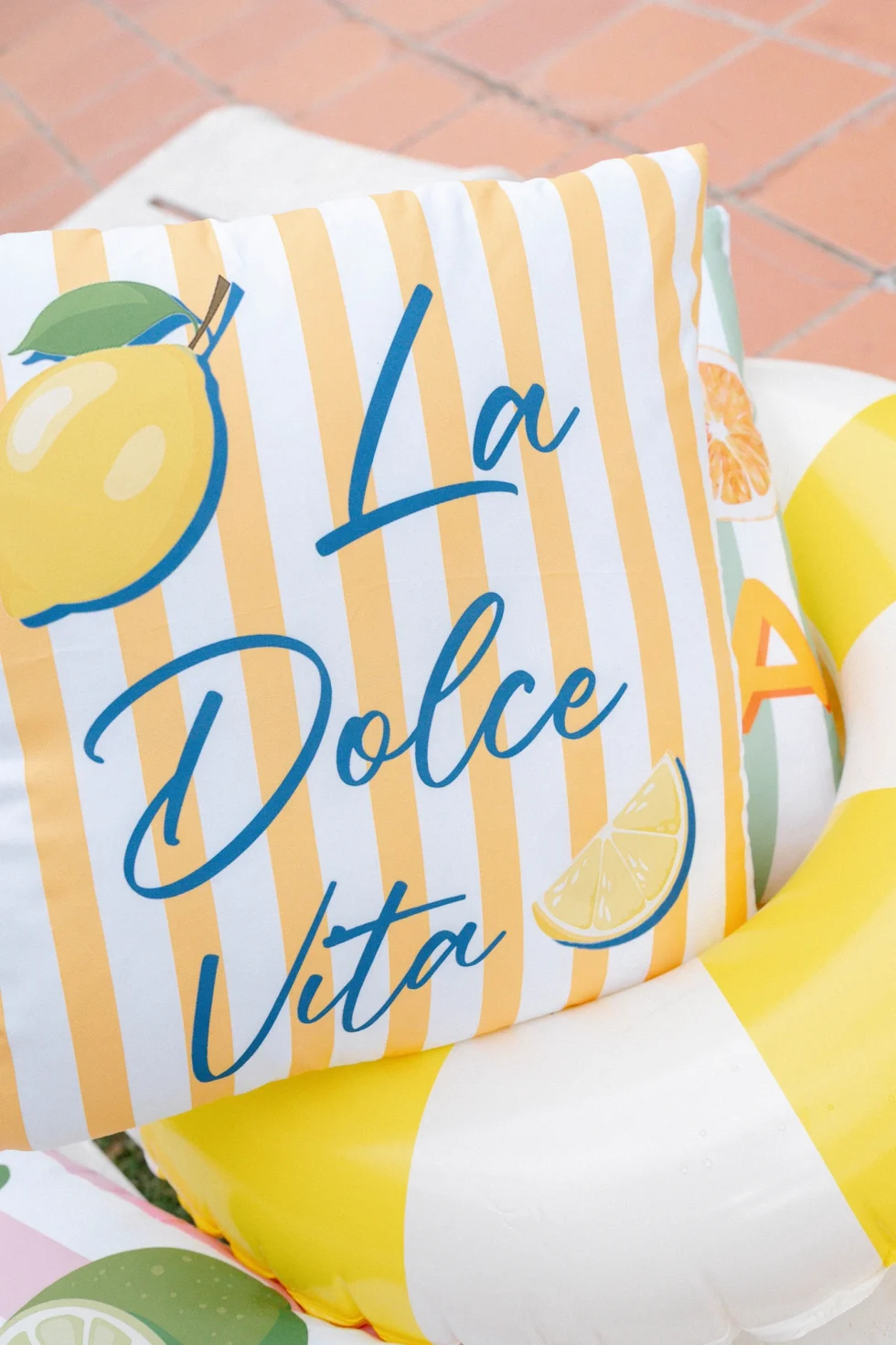 A lemon-print La Dolce Vita cushion by the pool at the welcome party, Palazzo di Bagnaia, Umbria
