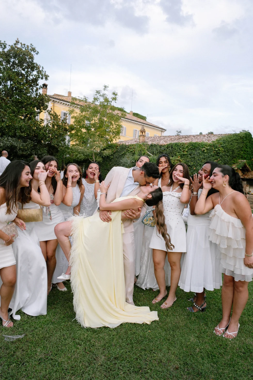 Hadi dips Suzanne for a kiss as her friends in white cheer, Palazzo di Bagnaia, Umbria