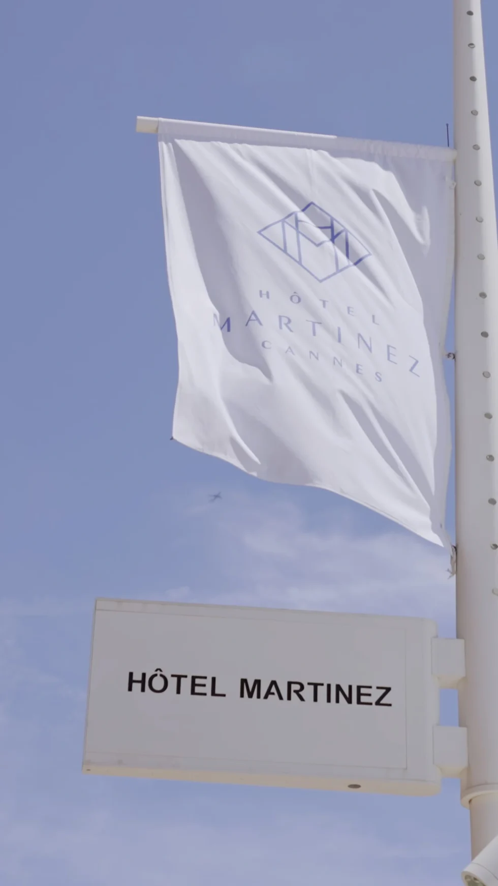 The flag of the Hôtel Martinez against the blue sky of Cannes