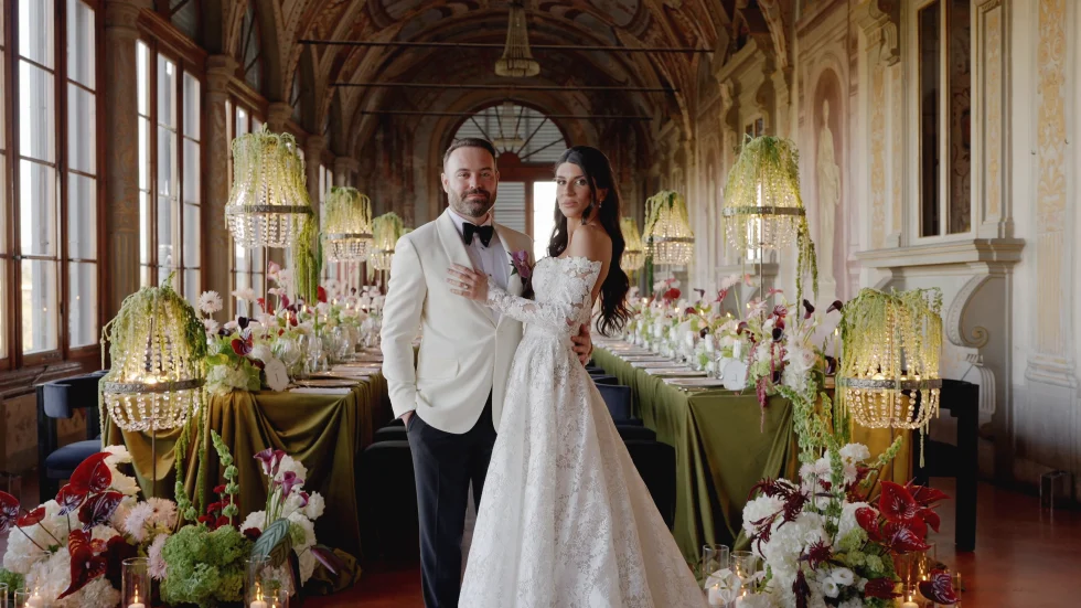 Jenna and Jameson in the frescoed loggia of Villa Corsini, beside their wedding dinner table, Florence