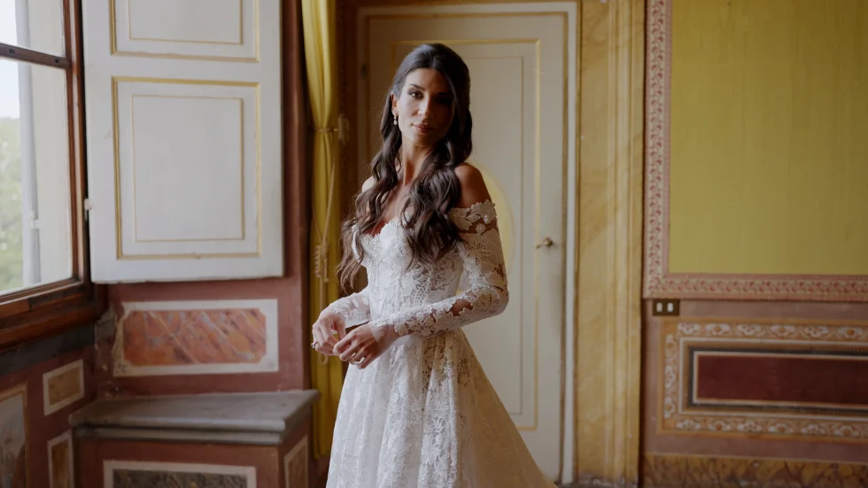 Jenna by a window of a frescoed room at Villa Corsini a Mezzomonte before the ceremony, Florence