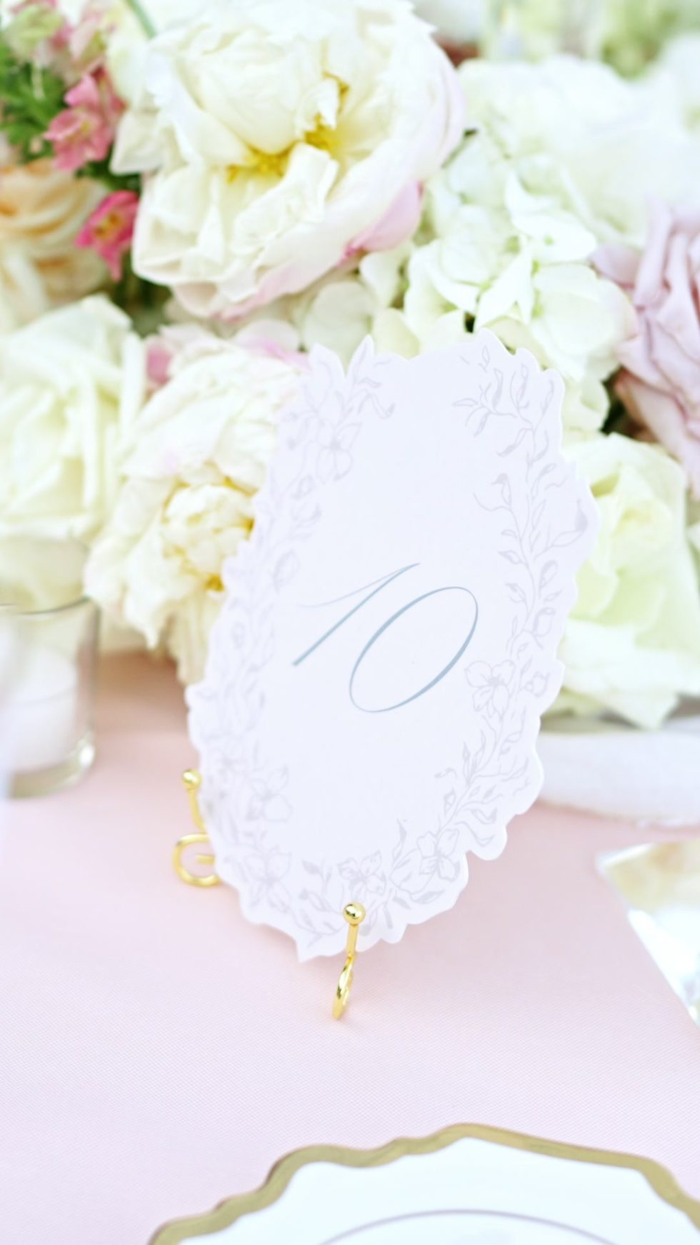 A table number among white and blush roses at the Ravello wedding reception