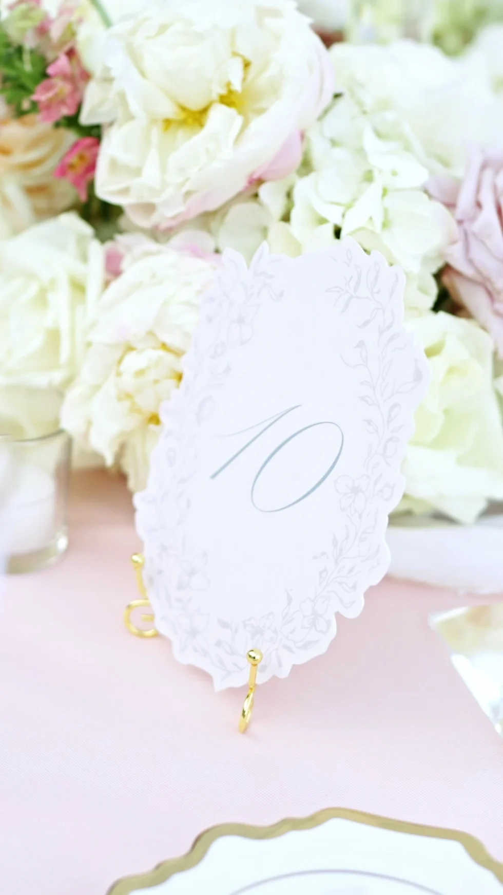 A table number among white and blush roses at the Ravello wedding reception