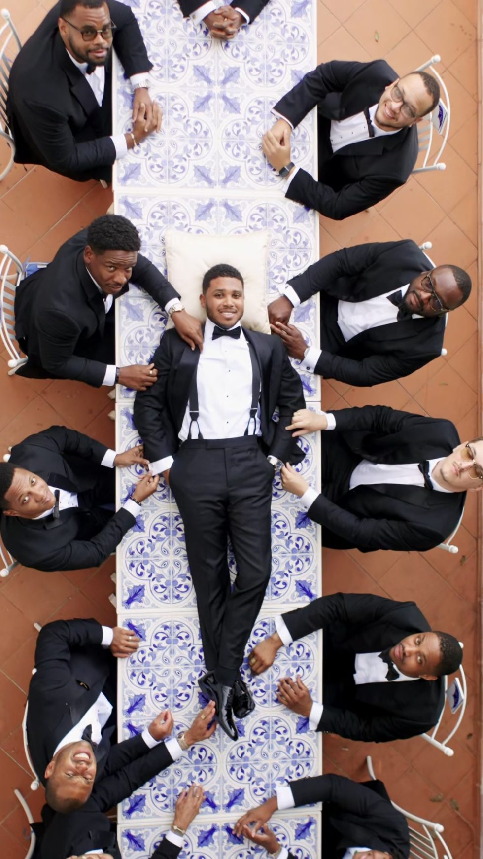 The groom and his groomsmen on the majolica tiles of La Rondinaia, seen from above