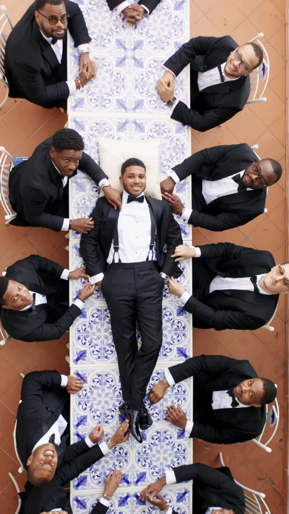 The groom and his groomsmen on the majolica tiles of La Rondinaia, seen from above