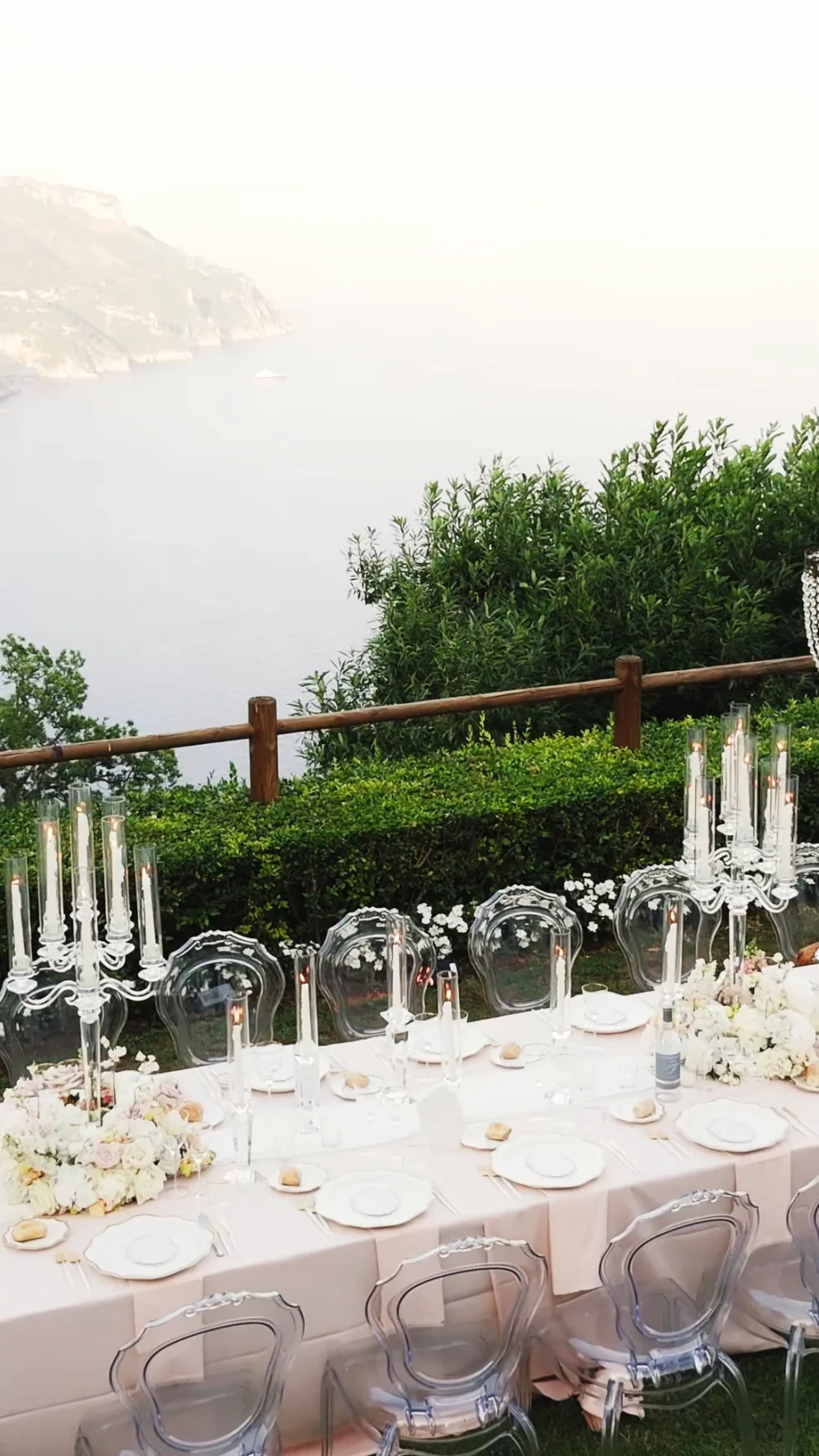 Candlelit reception tables above the sea at La Rondinaia, Ravello
